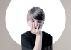 A young boy in a black shirt with his hand over his face A young boy in a black shirt with his hand over his face