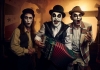 The Tiger Lillies: Men with white greasepaint and skeletal face paint, waistcoats and in instruments. The Tiger Lillies: Men with white greasepaint and skeletal face paint, waistcoats and in instruments.