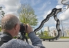 A man taking a photo of a statue on Warwick campus on his dslr camera A man taking a photo of a statue on Warwick campus on his dslr camera