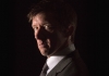 Comedian Jonathan Pie, wearing a suit and an earpiece, half in shadow and looking towards the camera Comedian Jonathan Pie, wearing a suit and an earpiece, half in shadow and looking towards the camera