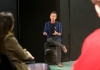 Chris O'Connell, the class teacher, sits on a speaker talking to students. He is wearing a blue checked shirt over a black tee shirt Chris O'Connell, the class teacher, sits on a speaker talking to students. He is wearing a blue checked shirt over a black tee shirt