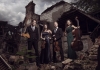 2 men and 2 women in formal dress stand with string instruments from violins to cellos, stand in front of an abandoned building 2 men and 2 women in formal dress stand with string instruments from violins to cellos, stand in front of an abandoned building
