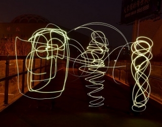 Swirls of yellow neon light against a darkened footpath Swirls of yellow neon light against a darkened footpath