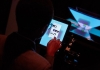 A young boy wearing glasses uses an electronic tablet A young boy wearing glasses uses an electronic tablet