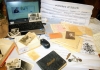 A laptop with a genealogy website on the screen, surrounded by papers and photograph albums A laptop with a genealogy website on the screen, surrounded by papers and photograph albums