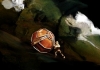 A mechanical puppet pushes a wooden boulder in front of a brooding, swirling sky A mechanical puppet pushes a wooden boulder in front of a brooding, swirling sky