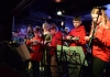 Children in uniforms play guitars on stage Children in uniforms play guitars on stage