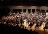 An orchestra made up of seated young musicians An orchestra made up of seated young musicians