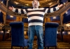 Richard Herring in a horizontally striped jumper, with his arms spread, in a theatre auditorium Richard Herring in a horizontally striped jumper, with his arms spread, in a theatre auditorium