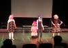 4 young performers on stage in colourful costumes 4 young performers on stage in colourful costumes