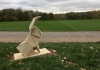 A stone origami hare on a green field A stone origami hare on a green field