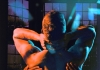 A man turned away from the camera, hands holding his back A man turned away from the camera, hands holding his back