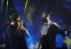 Two musicians in front of an abstract blue background. Two musicians in front of an abstract blue background.