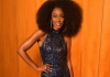 A woman in a sparkling blue dress stands against an orange background with her hand on her hip and smiles at the camera. A woman in a sparkling blue dress stands against an orange background with her hand on her hip and smiles at the camera.