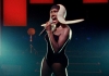 Garce Jones singing onstage in an elaborate outfit Garce Jones singing onstage in an elaborate outfit