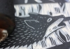 A linocut of a wolf in black ink A linocut of a wolf in black ink