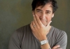 Alistair McGowan wears a grey shirt, looks into the camera and touches his face. Alistair McGowan wears a grey shirt, looks into the camera and touches his face.