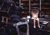 A child in a white dress and fairy wings sits on a pile of tyres and looks at the floor A child in a white dress and fairy wings sits on a pile of tyres and looks at the floor