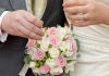 A bouquet of flowers held by two hands wearing wedding rings and holding champagne flutes A bouquet of flowers held by two hands wearing wedding rings and holding champagne flutes