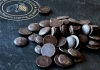 Chocolate buttons placed on a slate Chocolate buttons placed on a slate