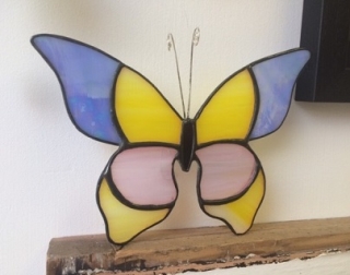 A stained glass butterfly decoration. A stained glass butterfly decoration.