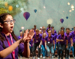 A child sings in the foreground. The background shows a choir of young people, with illustrations of hot air balloons behind them. A child sings in the foreground. The background shows a choir of young people, with illustrations of hot air balloons behind them.