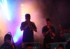 Young people playing brass instruments are backlit by blue and purple lights. "Jazz Matters" banners hang on their music stands. Young people playing brass instruments are backlit by blue and purple lights. "Jazz Matters" banners hang on their music stands.