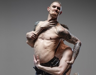 A photo of a man carrying another man who is topless with tattoos A photo of a man carrying another man who is topless with tattoos