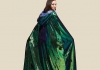 An image of a woman wearing a sparkly green cape An image of a woman wearing a sparkly green cape