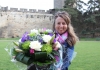 Blond woman holding a bouquet of flowers Blond woman holding a bouquet of flowers