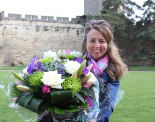 Blond woman holding a bouquet of flowers Blond woman holding a bouquet of flowers