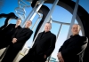 Coull Quartet musicians in black suits standing outside Coull Quartet musicians in black suits standing outside
