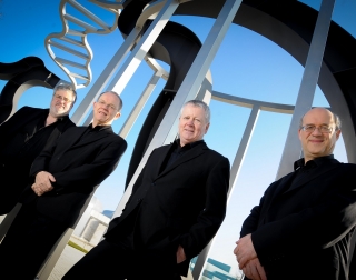 Coull Quartet musicians in black suits standing outside Coull Quartet musicians in black suits standing outside