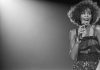 Singer Whitney Houston singing on stage Singer Whitney Houston singing on stage