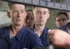 Actor John Hurt and other cast members in blue overalls Actor John Hurt and other cast members in blue overalls