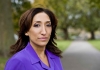 Shiza Mirza dressed in a purple shirt standing outside amongst trees Shiza Mirza dressed in a purple shirt standing outside amongst trees