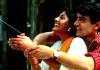A Hindu woman and a Muslim man smile as they fly a kite together. A Hindu woman and a Muslim man smile as they fly a kite together.