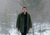 Investigator Harry Hole (Fassbender) walks in the snow, carrying a gun. Investigator Harry Hole (Fassbender) walks in the snow, carrying a gun.