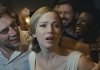Actress Jennifer Lawrence in a white dress trying to escape from a crowd of people as actor Javier Bardem smiles. Actress Jennifer Lawrence in a white dress trying to escape from a crowd of people as actor Javier Bardem smiles.