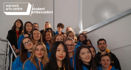 A group of student ambassadors pose for a photograph on the stairs A group of student ambassadors pose for a photograph on the stairs