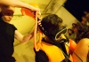 A man wearing a life vest and a scuba mask, connected to a funnel being held by another person A man wearing a life vest and a scuba mask, connected to a funnel being held by another person
