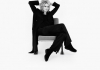 A black and white image of Joanna Lumley sitting on a chair with her hands hand behind her head A black and white image of Joanna Lumley sitting on a chair with her hands hand behind her head
