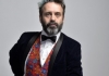 Comedian Phil Nichol wearing a suit against a white background Comedian Phil Nichol wearing a suit against a white background
