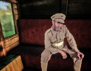A soldier sitting on a train bench A soldier sitting on a train bench