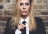 Comedian Sara Pascoe wearing a suit and leaning against a brick wall Comedian Sara Pascoe wearing a suit and leaning against a brick wall