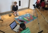 Two kids with filming equipment and a laptop Two kids with filming equipment and a laptop