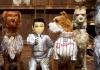 Animated. A young boy in a silver suit holding a picture of his lost dog surrounded by three different dogs. Animated. A young boy in a silver suit holding a picture of his lost dog surrounded by three different dogs.