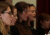 Close shot of four girls wearing black and singing Close shot of four girls wearing black and singing