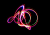 Abstract lines in neon colours against a black background Abstract lines in neon colours against a black background
