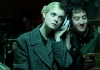 Actress Elle Fanning wearing a tweed coat and listening to music on big white earphones that she is sharing with a young man Actress Elle Fanning wearing a tweed coat and listening to music on big white earphones that she is sharing with a young man
